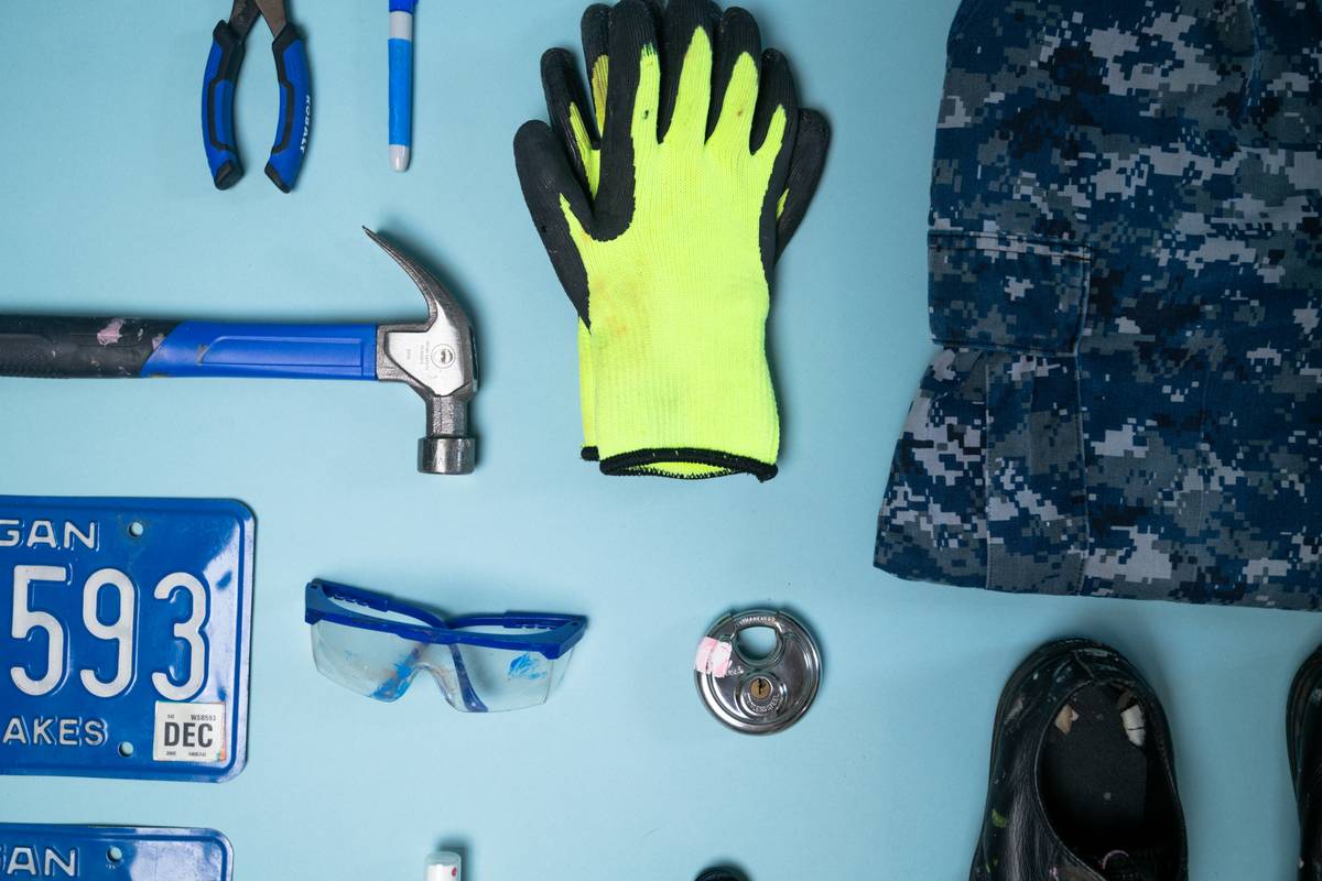 safe use of power tools: homeowner wearing goggles and gloves while operating a circular saw on a stable workbench