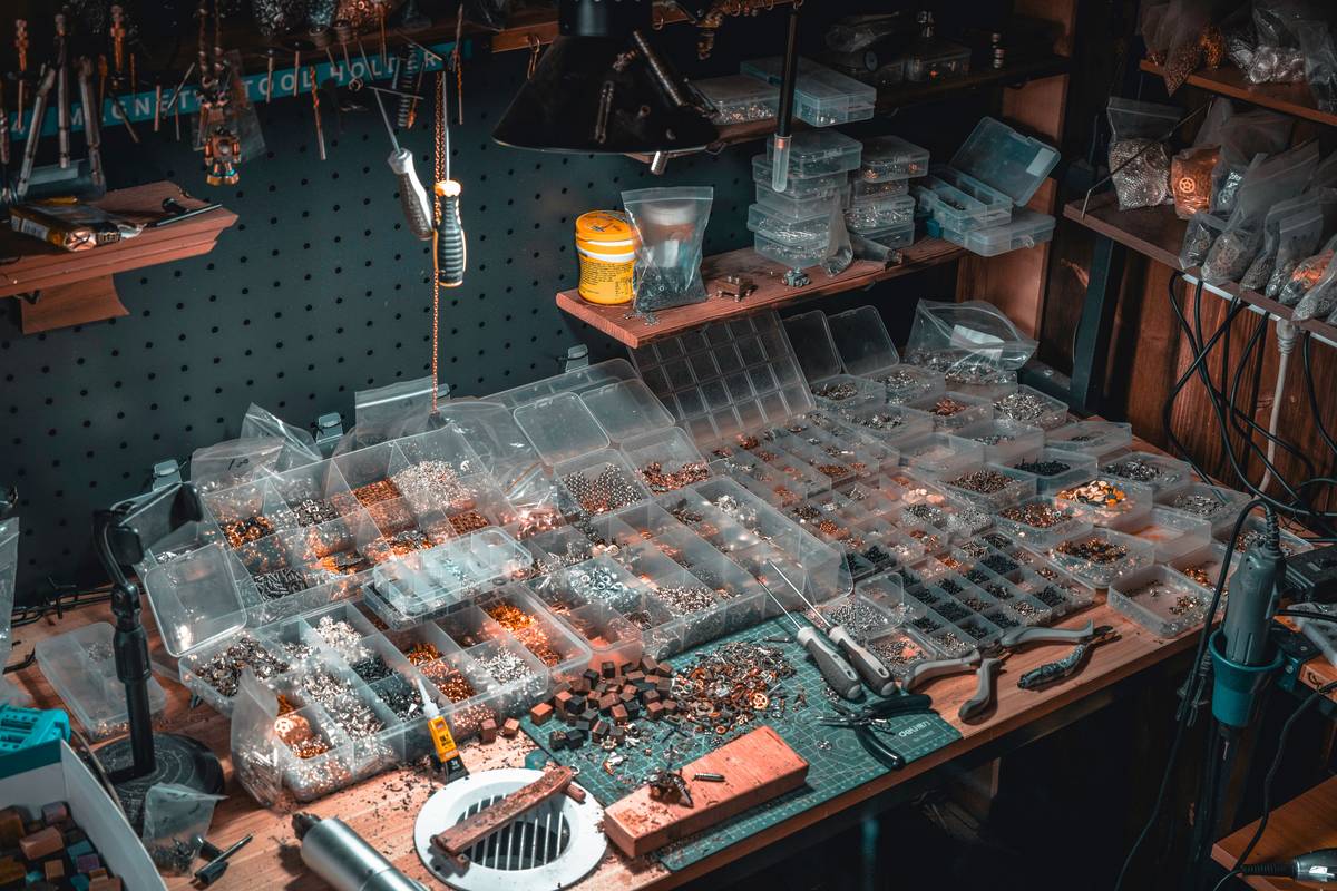 list of power tools arranged neatly on a workbench including drill, circular saw, jigsaw, orbital sander, and multi-tool